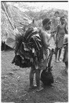 Woman bringing leaves for making the leaf oven