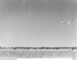 FORBES, NSW. 1943-02. GAS SHELL EXPERIMENTS CARRIED OUT BY 2/1 AUSTRALIAN CHEMICAL WARFARE LABORATORY AND 2/2 FIELD REGIMENT, ROYAL AUSTRALIAN ARTILLERY. THE EFFECTIVE BURST. THE DROPS WILL DRIFT ..