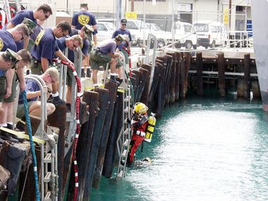 US Navy (USN) divers from Mobile Diving and Salvage Unit ONE (MDSU-1) and Japanese divers from Ship Repair Facility, Yokosuka, Japan, conduct pier-side dry-suit indoctrination at the MDSU compound in Pearl Harbor, Hawaii (HI)