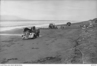 SIAR, NEW GUINEA. 1944-06-20. HANSA BAY, NEW GUINEA. 1944-06-20. JAPANESE ARMY TRUCKS ABANDONED ON THE BEACH BETWEEN AWAR POINT AND CONDOR POINT DURING THE ENEMY RETREAT IN THE AREA