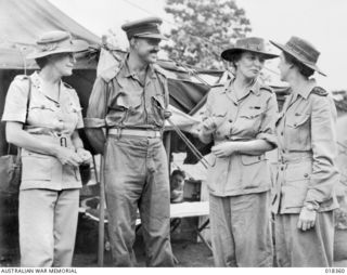 New Britain. 1945-04. Left to right: Lady Blamey, Colonel N. H. W. Saxby, Lady Wakehurst and Senior Sister K. Barnes of Western Australia, at a casualty clearing station during an official visit by ..