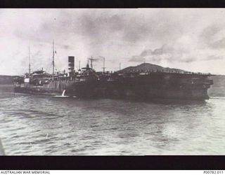 RABAUL, NEW BRITAIN, 1946-02-28. JAPANESE AIRCRAFT CARRIER KATSURAGI EMBARKING JAPANESE PRISONERS FOR REPATRIATION AFTER THE WAR. (DONOR: J. DEEBLE)