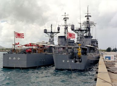 Starboard quarter view of the Japanese frigates JDS TOKACHI (DE 218), right, and JDS OOI (DE 214) moored in Apra Harbor