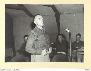 BOSLEY FIELD, BOUGAINVILLE, SOLOMON ISLANDS. 1945-03-15. N255937 PRIVATE W.H. COTTIER, 227TH SUPPLY DEPOT PLATOON (1), (BARITONE), PARTICIPATING IN THE AMATEUR PROGRAMME "STARS IN UNIFORM" ..