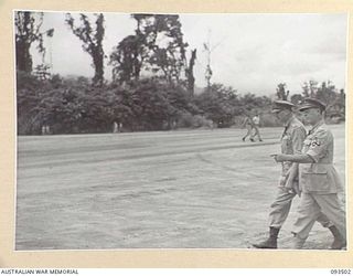 TOROKINA, BOUGAINVILLE. 1945-07-03. HIS ROYAL HIGHNESS, THE DUKE OF GLOUCESTER, GOVERNOR-GENERAL OF AUSTRALIA (1), AFTER ARRIVAL AT PIVA AIRSTRIP MOVING TO THE SALUTING BASE ACCOMPANIED BY ..