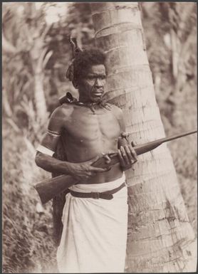 A guard of Fiu holding a rifle, north-west Malaita, Solomon Islands, 1906 / J.W. Beattie