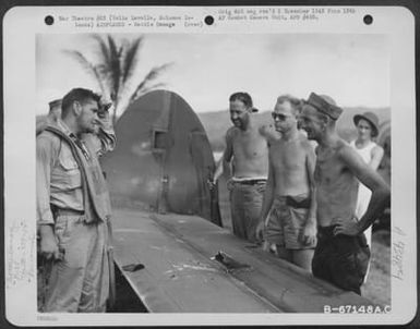 The Shell-Scarred Tail Of This Lockheed P-38 Of The 339Th Fighter Squadron, 12Th Fighter Group, Verifies The Experiences Which Lt. D.W. Livsey Of El Cajon, California, Is Relating To Men Who Have Crowded Around The Crashed Plane At Vella Lavella, Solomon (U.S. Air Force Number B67148AC)