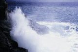 Oceania, waves crashing along shoreline of island in South Pacific
