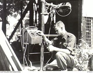 MADANG, NEW GUINEA. 1944-08-25. QX38750 STAFF SERGEANT W.W. DROVER, X-RAY TECHNICIAN TESTING A NEW PORTABLE X-RAY MACHINE (SF 1 TYPE) BEING INSTALLED IN THE 2/11TH GENERAL HOSPITAL