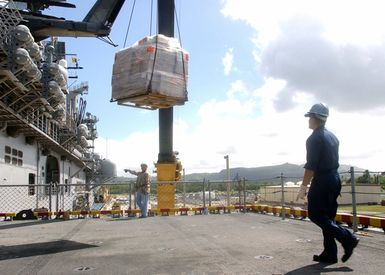 Supplies are craned onto the Wasp Class Amphibious Assault Ship USS BONHOMME RICHARD (LHD 6) during a brief port visit to the Pacific island of Guam. The BONHOMME RICHARD promptly changed her deployment schedule to support Operation UNIFIED ASSISTANCE, the humanitarian relief effort in the wake of the Tsunami that struck South East Asia on December 26 2004