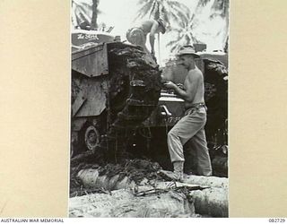 MADANG, NEW GUINEA. 1944-10-12. MAINTENANCE WORK ON A TANK DURING TESTS CONDUCTED AT HQ 4 ARMOURED BRIGADE