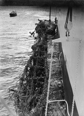 [High angle view of a boat with many Pacific island people]