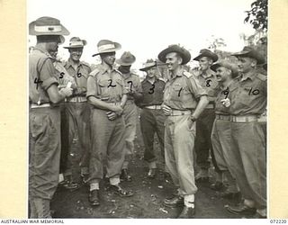 GUSIKA, NEW GUINEA. 1944-04-09. VX14643 CAPTAIN T.J. HARRIS, MC, (1), WITH FELLOW OFFICERS OF THE 2/4TH LIGHT ANTI-AIRCRAFT REGIMENT AFTER RECEIVING THE MILITARY CROSS. THE AWARD WAS WON DURING A ..