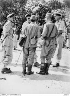 LOSSUK BAY, NEW IRELAND. 1945-10-19. CAPTAIN F.N.W. SHAND, AUSTRALIAN NEW GUINEA ADMINISTRATIVE UNIT DISTRICT OFFICER (1), LIEUTENANT P. MILLISON, ROYAL AUSTRALIAN NAVY (2) AND LIEUTENANT COMMANDER ..