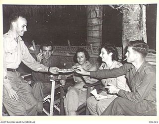 PALMALMAL PLANTATION, JACQUINOT BAY, NEW BRITAIN. 1945-07-17. AUSTRALIAN ARMY MEDICAL WOMEN'S SERVICE AND SERGEANTS AT SUPPER DURING INTERVAL AT A SPECIAL DANCE HELD IN THE AUSTRALIAN ARMY MEDICAL ..