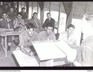 TOROKINA, BOUGAINVILLE, 1945-10-27. SERGEANT R. ADAMS, AN INSTRUCTOR OF THE ACADEMIC WING, INSTRUCTING IN ENGLISH AT THE TOROKINA REHABILITATION CENTRE