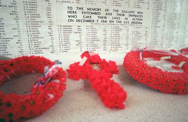 Commemorating the 50th anniversary of the Dec. 7th, 1941, attack on Pearl Harbor, wreaths line the USS ARIZONA Memorial wall engraved with the names of the battleship's crew who died in the bombing