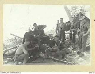 KOMANA POINT, NEW GUINEA. 1944-07-30. PERSONNEL OF D COMPANY, 30TH INFANTRY BATTALION DOING A MAINTENANCE OVERHAUL ON A 2 POUNDER TANK ATTACK GUN IN THE COMPANY AREA. IDENTIFIED PERSONNEL ARE:- ..