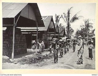 TOL AREA, NEW BRITAIN. 1945-08-02. NATIVES HANDLING STORES AT TOL DETAIL ISSUE DEPOT, OPERATED BY 250 SUPPLY DEPOT PLATOON