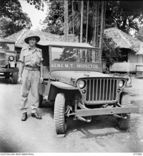 LAE, NEW GUINEA. 1944-08-22. VX138611 CAPTAIN E.C. IZOD, OFFICER- IN- CHARGE, 12TH MOTOR TRANSPORT INSPECTION SECTION, STANDING BESIDE HIS JEEP BEFORE SETTING OUT FOR AN INSPECTION TOUR OF HIS ..