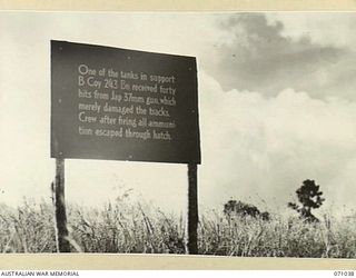FINSCHHAFEN AREA, NEW GUINEA. 1944-03-13. ONE OF MANY BATTLE SIGNS IN THE FINSCHHAFEN AREA, THIS SIGN AT THE LAKES AREA RECORDS THE ACTIVITIES OF A TANK SUPPORTING "B" COMPANY, 2/43RD INFANTRY ..