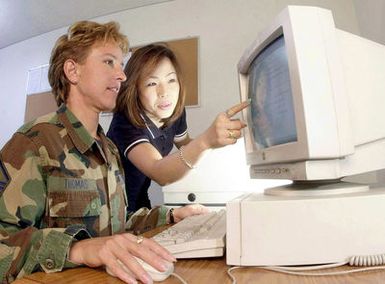 Air Force MASTER Sergeant Gayle Thomas and Hiroe Aoki, both members of the Defense Finance and Accounting Service-Japan, use a centralized disbursing system to verify yen payments to local vendors here. The mission of DFAS-J is to provide finance and accounting services to Department of Defense (DOD) activities operating in Japan and the Western Pacific. This includes accounting, vendor pay, financial reporting, and disbursing services for Army, Air Force, Navy and Marine activities operating out of Japan, Korea, Singapore, Guam, Diego Garcia, and Okinawa