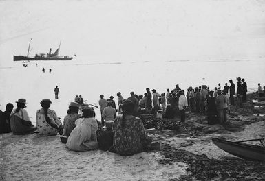 Sears, Frederick W, fl 1890s-1900s (Photographer) : Crowd on the island of Mangaia, Cook Islands, with the ship `Tutanekai' in the distance