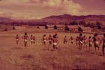 Schoolboys running across field, Mount Hagen, New Guinea