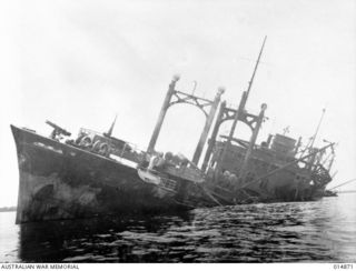 1943-05-19. NEW GUINEA. GONA. THIS WRECKED JAPANESE SHIP "AYATOSAN MARU", SUNK BY ALLIED AIRCRAFT DURING THE BATTLE OF GONA. IT IS NOW USED FOR TARGET PRACTICE BY ALLIED FORCES AT GONA BEACH. ..