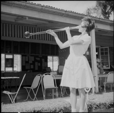 A woman drinking beer out of a yard glass at the Suva Bowling Club, Suva, Fiji, November 1969 / Michael Terry