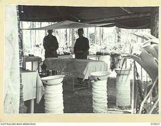 NAGADA, NEW GUINEA. 1944-08-02. THE TENT OPERATING THEATRE OF THE 4TH FIELD AMBULANCE. IDENTIFIED PERSONNEL ARE:- VX106535 SERGEANT T. MORGAN (1); VX106539 SERGEANT L. MCMURRAY (2)