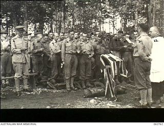 Dumpu, Ramu Valley, New Guinea. 1943-12-25. SX1476 Chaplain D. L. Redding, (Church of England) Senior Chaplain, 7th Division (22), assisted by VX39632 Chaplain F. J. Hartley (Presbyterian) (21) ..