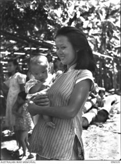 RABAUL AREA, NEW BRITAIN. 1945-09-13. CHINESE CIVILIANS, INTERNED BY THE JAPANESE AT A CAMP 15 MILES WEST OF RABAUL, WERE CONTACTED BY A PARTY OF AUSTRALIAN ARMY AND RED CROSS OFFICIALS SOON AFTER ..