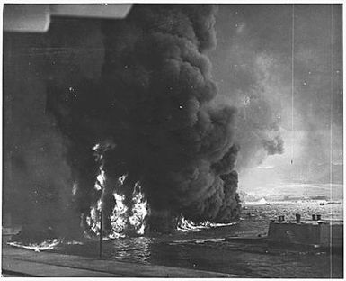 Naval photograph documenting the Japanese attack on Pearl Harbor, Hawaii which initiated US participation in World War II. Navy's caption: Oil burning on top of water near the Naval Air Station after the Japanese "sneak attack" on Pearl Harbor of Dec. 7, 1941.