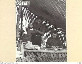 SIAR, NEW GUINEA. 1944-06-25. VX142375 PRIVATE R.A. RYALL (1) AND VX141661 PRIVATE P.J. DELAHUNTY (2), 57/60TH INFANTRY BATTALION SORTING MAIL IN THE UNIT POSTAL TENT