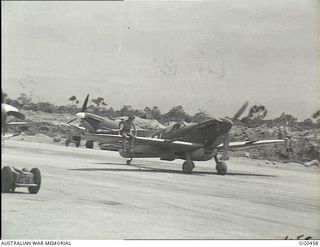 KIRIWINA, TROBRIAND ISLANDS, PAPUA. 1944-01-11. THE WEATHER IS HOT WHERE THE SPITFIRE AIRCRAFT OF NO. 79 (SPITFIRE) SQUADRON RAAF ARE OPERATING IN THE NEW GUINEA AREA AND GROUND CREWS SAVE ENERGY ..