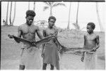 Man and two boys holding captured bats