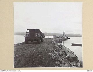 WIDE BAY, NEW BRITAIN. 1945-05-02. A TIP-TRUCK ON THE CAUSEWAY BEING BUILT BY 13 FIELD COMPANY, ROYAL AUSTRALIAN ENGINEERS, SAPPERS. THE CAUSEWAY WILL LEAD TO A NEW WHARF BEING CONSTRUCTED FOR ..