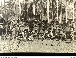 MADANG, NEW GUINEA. 1944-06-17. PERSONNEL OF THE MEDIUM MACHINE GUN PLATOON ATTENDING A LECTURE AT HEADQUARTERS COMPANY, 58/59TH INFANTRY BATTALION. THE UNIT IS LOCATED AT SIAR PLANTATION. LEFT TO ..