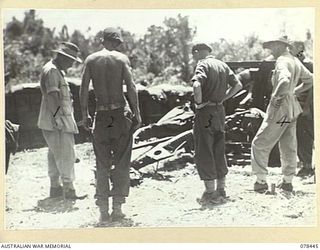 MOTUPINA POINT AREA, BOUGAINVILLE ISLAND. 1945-01-20. VX86 BRIGADIER W.E. CREMOR, OBE, ED, COMMANDER CORPS ROYAL ARTILLERY, 2ND AUSTRALIAN CORPS (1) LOOKING OVER THE GUN POSITIONS OF NO.5 BATTERY, ..