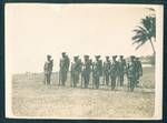 Native Police ready for inspection of [Evan Alexander Wisdom, administrator of the Mandated Territory of New Guinea?], Kavieng District Office, Kavieng, New Ireland, New Guinea, Sep 1930