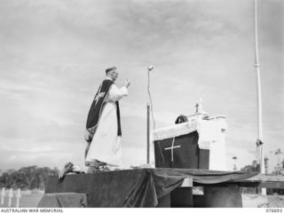 LAE, NEW GUINEA. 1944-11-05. NX369 CHAPLAIN P. T. BOLAND, ASSISTANT CHAPLAIN GENERAL, (ROMAN CATHOLIC) ASSISTED BY VX135323 PRIVATE G. G. MEREDITH, CELEBRATING A SOLEMN REQUIEM MASS AT THE ALTAR ON ..