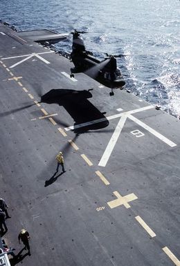 A right side view of a CH-46 Sea Knight helicopter preparing to touch down on the deck of the amphibious assault ship USS SAIPAN (LHA-2) during exercise Ocean Venture '81