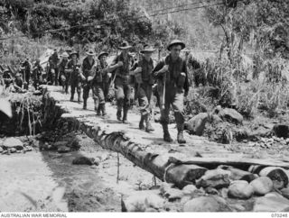 FARIA VALLEY, NEW GUINEA, 1944-02-09. MEMBERS OF "A" COMPANY, 2/10TH INFANTRY BATTALION CROSSING THE FARIA RIVER AT BEVERIDGE'S POST, NEAR GUY'S POST