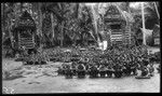 Hookworm lecture in front of yam houses, at Kiriwina Island