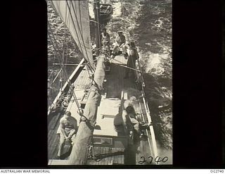 PORT MORESBY, PAPUA. C. 1944. CREW MEMBERS ON THE DECK OF A SAILING VESSEL USED BY THE RAAF RESCUE SERVICE