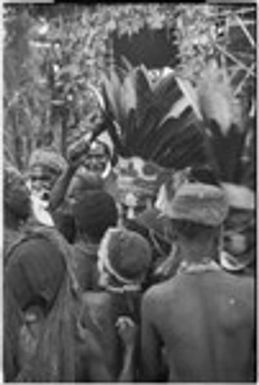 Bride price ritual: bride with headdress and bush knife