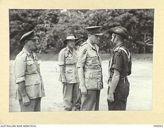 TOROKINA, BOUGAINVILLE. 1945-03-30. LORD WAKEHURST, GOVERNOR OF NEW SOUTH WALES (3), SPEAKING WITH MAJOR W. MCCALL, COMMANDER OF THE GUARD OF HONOUR, 57/60 INFANTRY BATTALION (4), AFTER HIS ARRIVAL ..