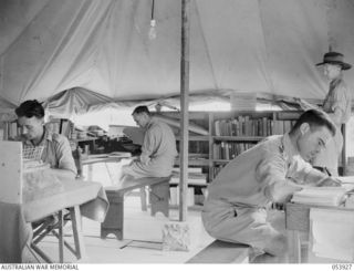 PORT MORESBY, NEW GUINEA. 1943-07-13. LIBRARY AT THE PORT MORESBY EDUCATION CENTRE, AUSTRALIAN ARMY EDUCATION SERVICE. LEFT TO RIGHT: SX16426 SERGEANT (SGT) L. W. WHALEN, NON-COMMISSIONED OFFICER ..