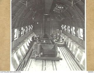 PORT MORESBY, NEW GUINEA, 1943-11-15. INSIDE THE DOUGLAS TRANSPORT AIRCRAFT SHOWING THE SMALL AMOUNT OF SPACE NECESSARY TO STOW A SHORT 25-POUNDER GUN AFTER IT HAS BEEN DISMANTLED